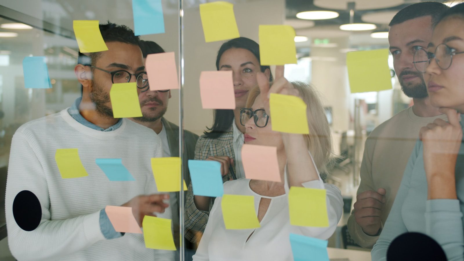 Agentic Enterprise: 7 Powerful 2026 Wins Beyond Chatbots 13 team moving beyond chatbots with sticky notes for enterprise AI workflow design