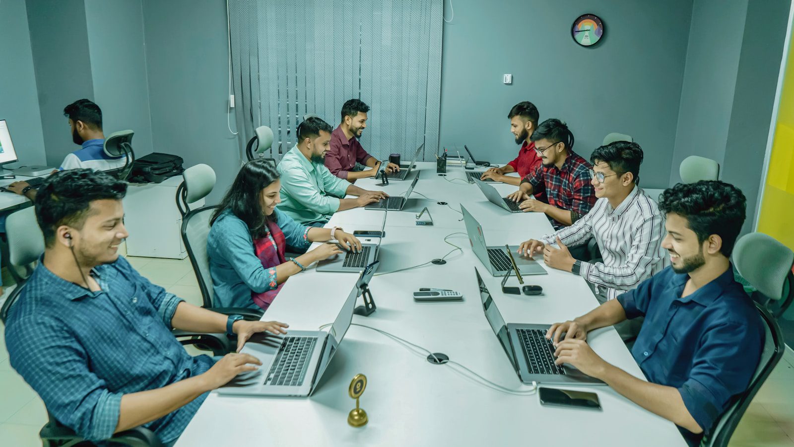 AI ROI Gap: 7 Proven Ways to Turn Pilots Into Profit 21 production AI product team collaborating around laptops to scale pilot results