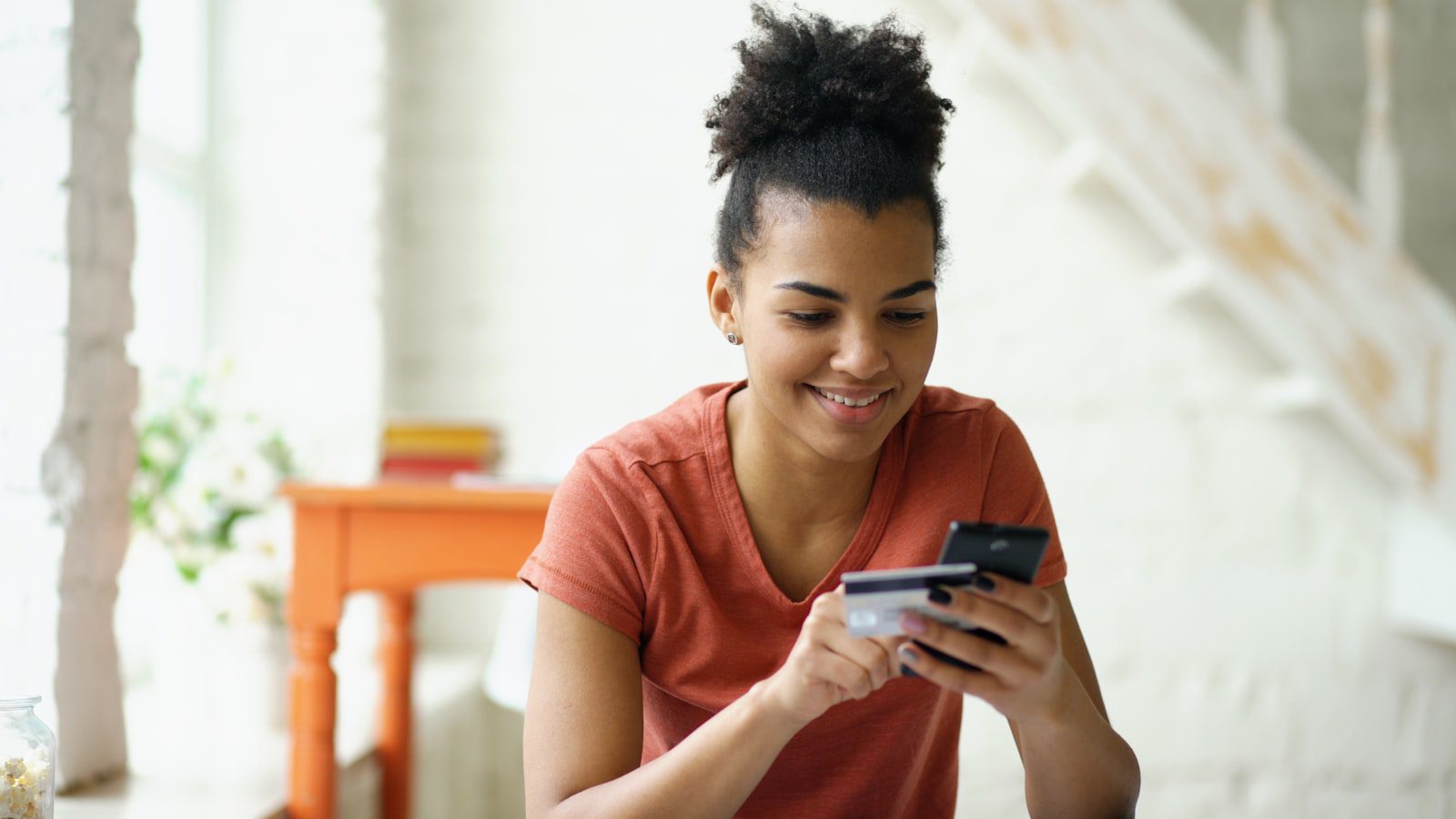 Anthropic AI Model: 7 Alarming Bank Security Lessons 22 Mobile banking user with phone and card representing customer questions about AI bank security