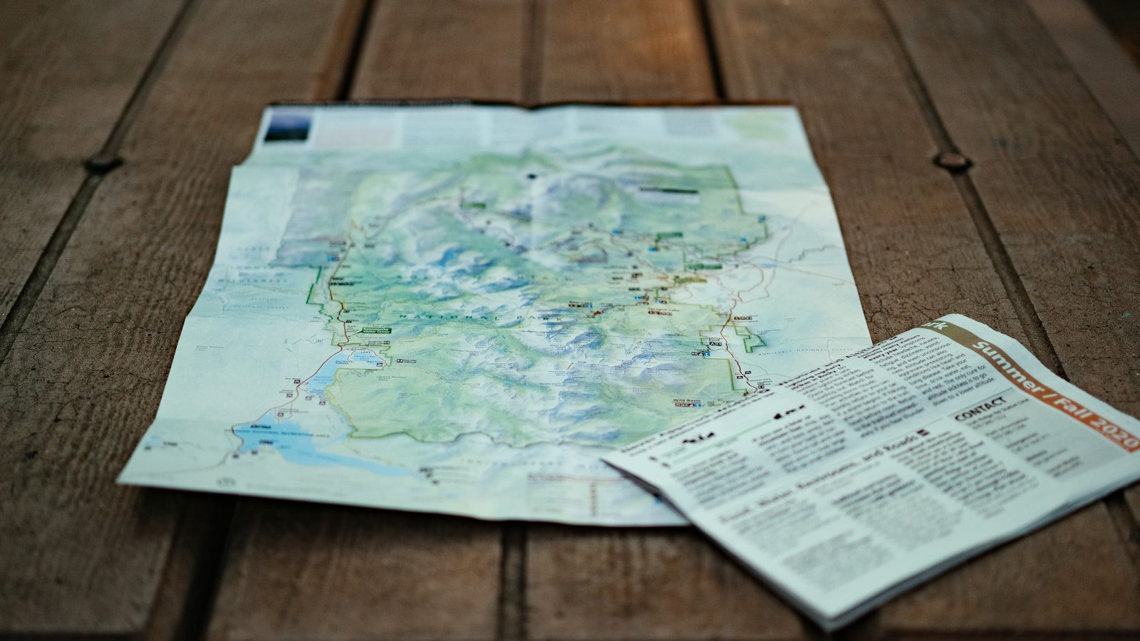 Ask Maps: 7 Powerful Ways Gemini Makes Travel Smarter 18 Ask Maps evaluation with travel maps and route planning documents on a table