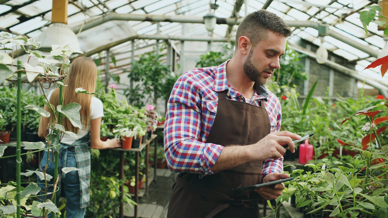 Crescendo.ai: 7 Powerful Real-World AI Case Studies 17 Greenhouse worker using tablet representing Rachio connected-device AI customer support