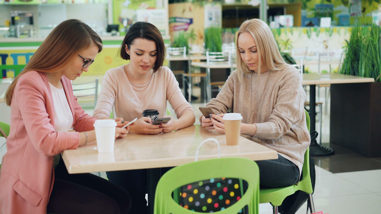 Crescendo.ai: 7 Powerful Real-World AI Case Studies 18 Cafe customers using smartphones representing Starbucks AI personalization and mobile ordering