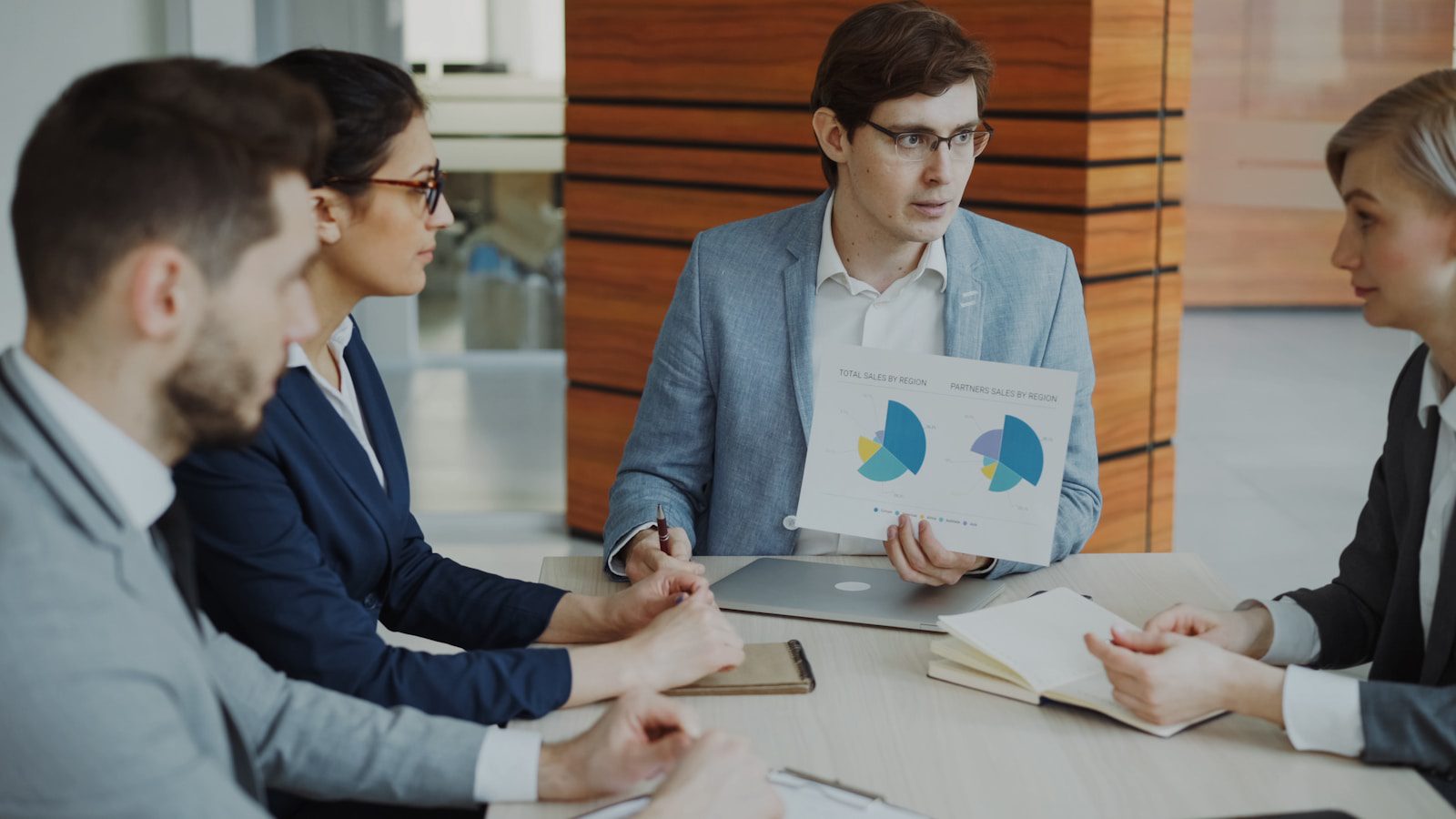 AI-Driven Refactoring: 7 Smart Mainframe Wins Today 27 Technology team discussing charts for a mainframe modernization pattern