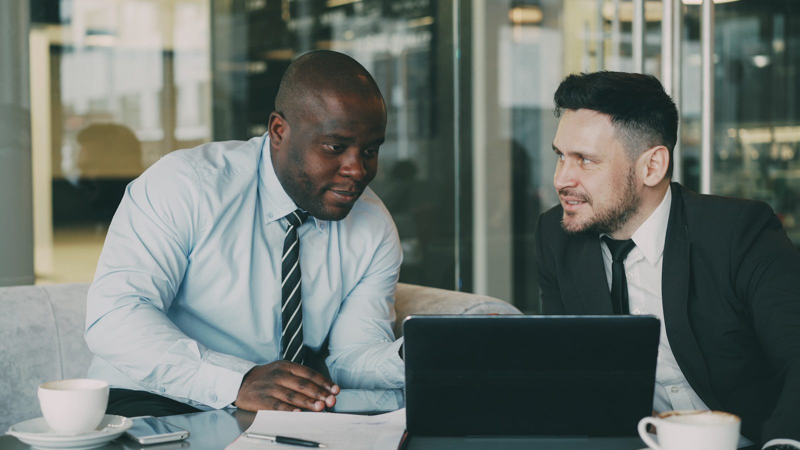 Mendix vs. OutSystems: 7 Powerful Agentic Low-Code Wins 19 Business team reviewing documents to choose an enterprise low-code platform