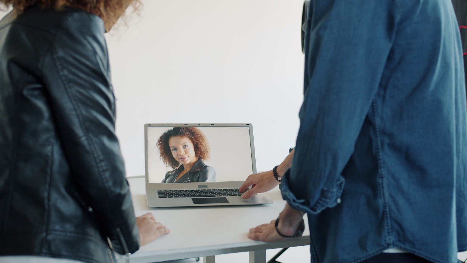 Team collaboration on a laptop representing accountable AI agent teammates