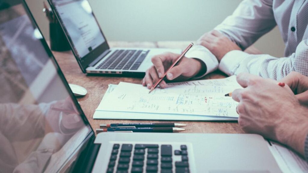 Anthropic Agent Lock-In procurement checklist illustrated by business papers and technology planning work