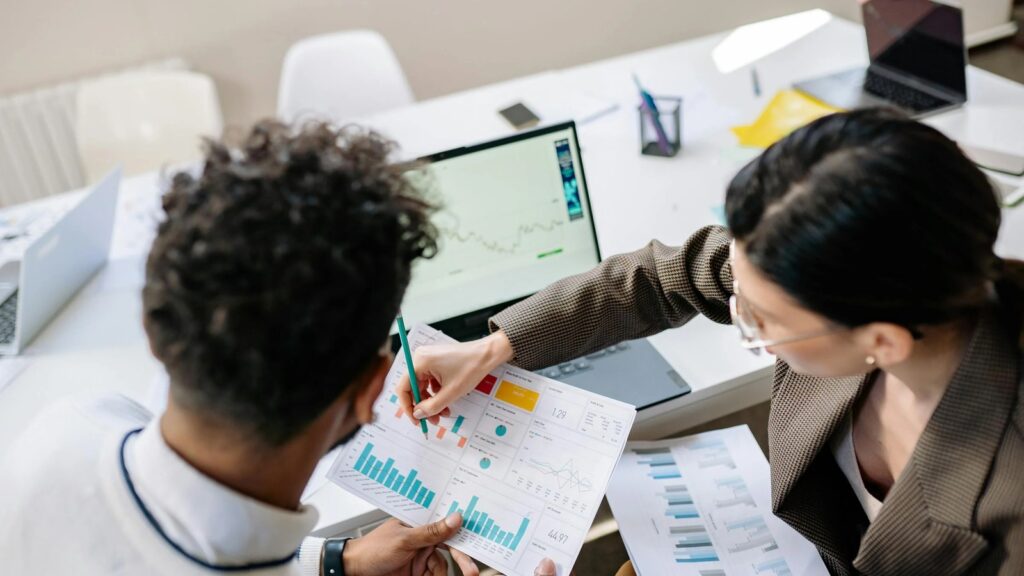 Business Central reporting shown through colleagues reviewing graphs and analytics