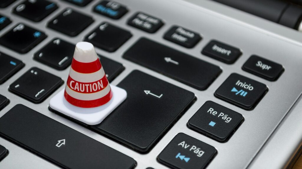 Chrome AI Privacy wording change represented by a caution cone on a keyboard