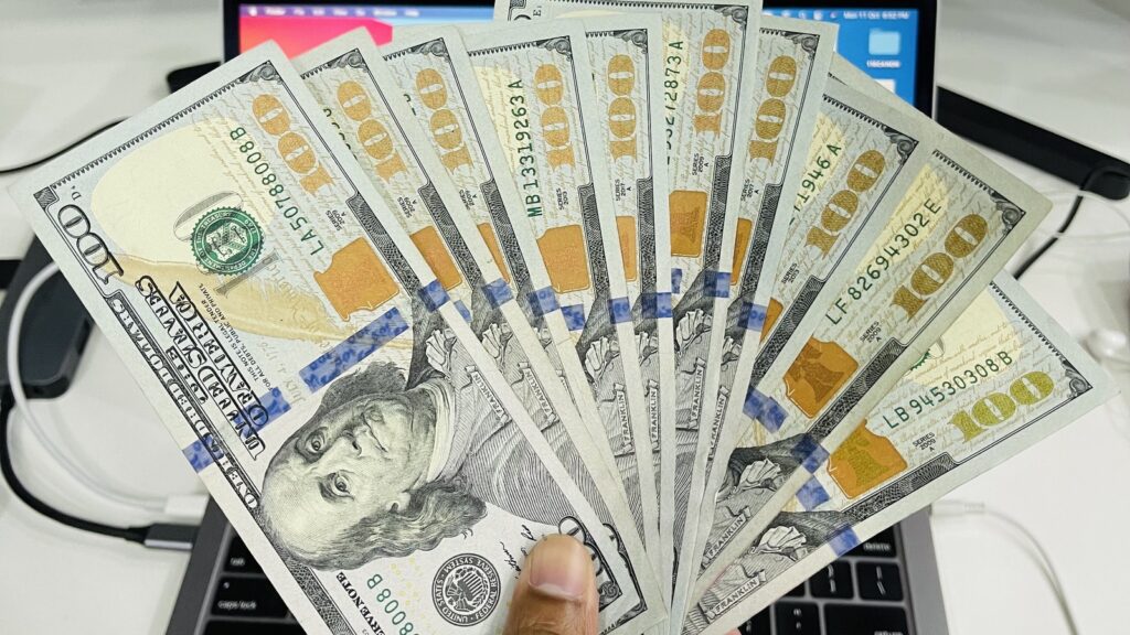 DORA compliance planning for finance systems shown by banknotes over a laptop