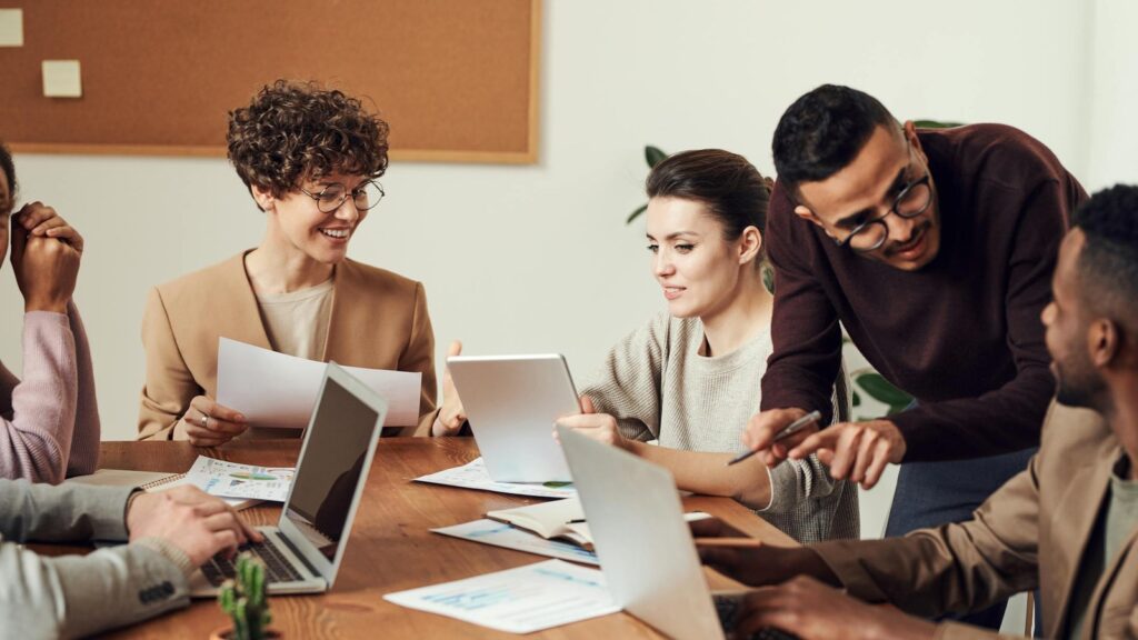 GPT-5.5 Instant Microsoft Copilot workplace rollout represented by a team reviewing documents and laptops