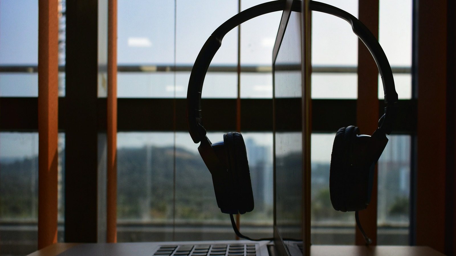 GPT-Realtime-2 Voice Agents shown by an office laptop with a headset for live support
