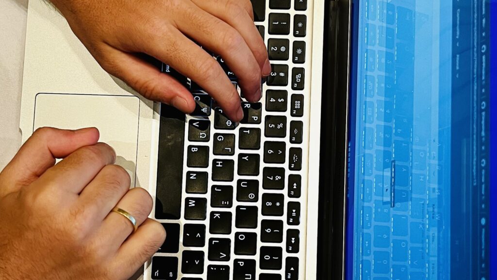 Gemini 3.1 Flash-Lite Browser shown through a person typing on a laptop beside a phone for practical web tasks