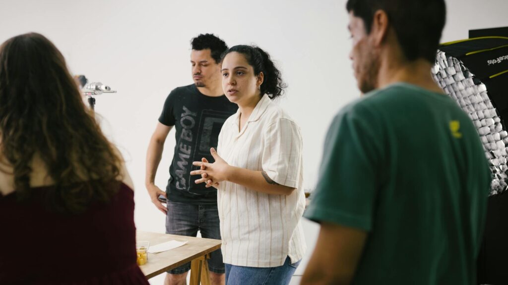 GeniLoop multi-model AI creative studio workflow represented by a team collaborating in a studio setting.