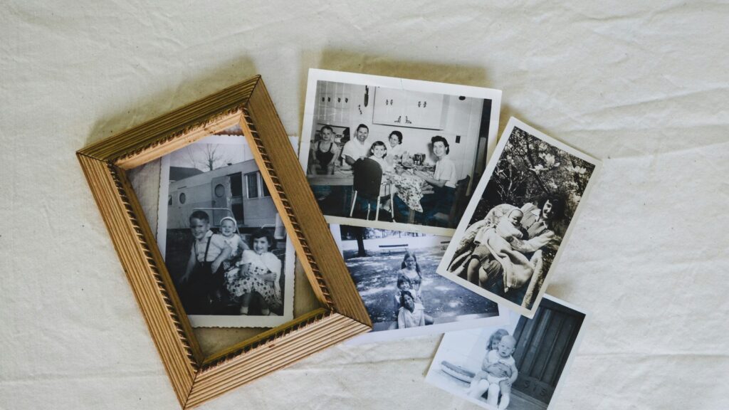 HitPaw Photo Restoration old photo repair shown through black-and-white family photos on a white sheet.