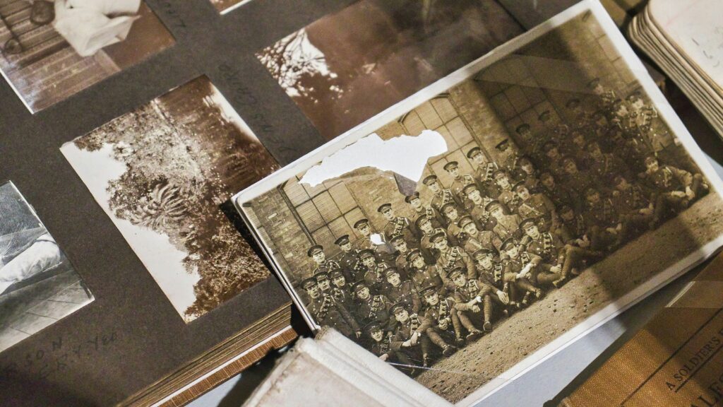 HitPaw Photo Restoration colorization concept shown through an old group photo on a table.