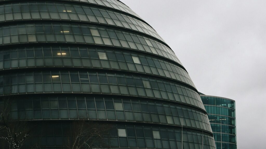 Modern London glass office building representing governance for Li-Fi security deployments