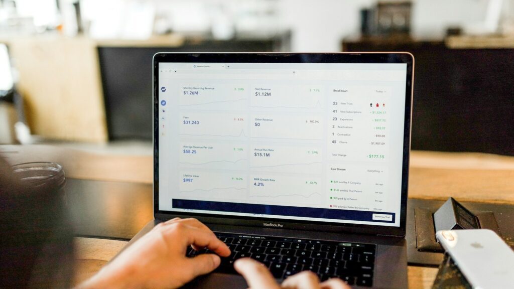 Person using a laptop dashboard during an internal software review