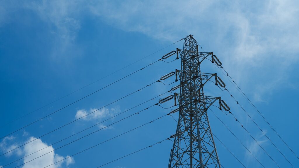 Power-Independent Infrastructure grid resilience shown by electricity transmission tower and power lines