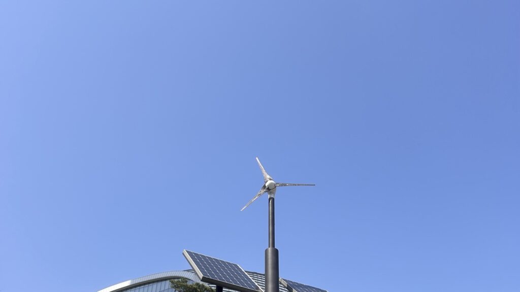 Power-Independent Infrastructure local energy shown by solar panels and small wind turbine on a street light