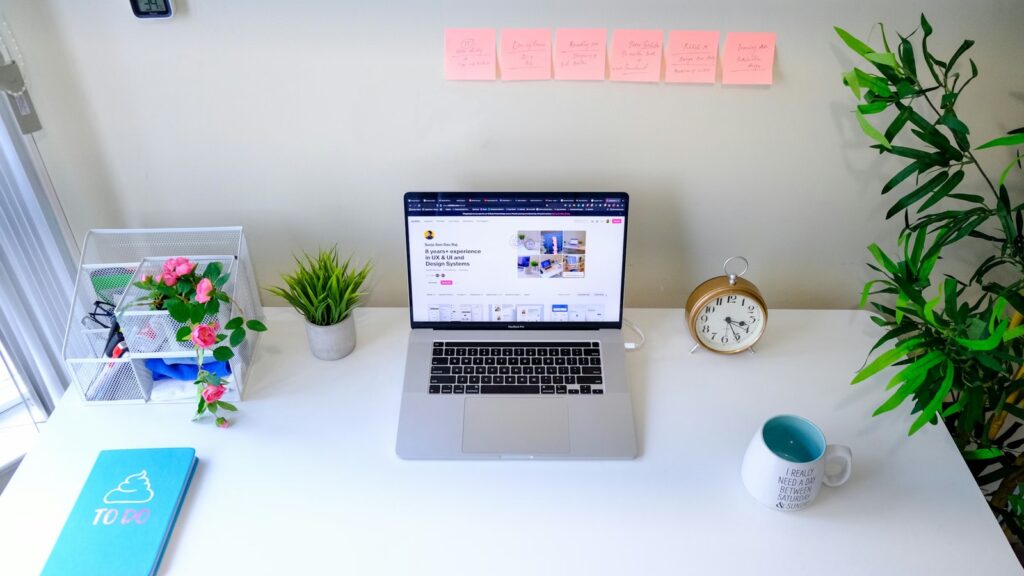 Quiet laptop desk with books and a clock representing Right to Disconnect rest periods