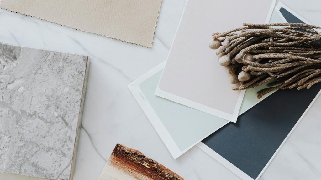 Seed3D 2.0 PBR materials represented by paint, paper, and textile material samples on a design desk