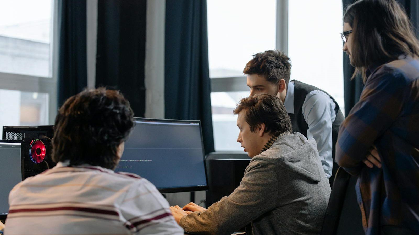 Atoms Review: 7 Smart Ways to Build AI Apps Faster 11 Atoms AI app builder overview with developers collaborating on product screens in a modern workspace