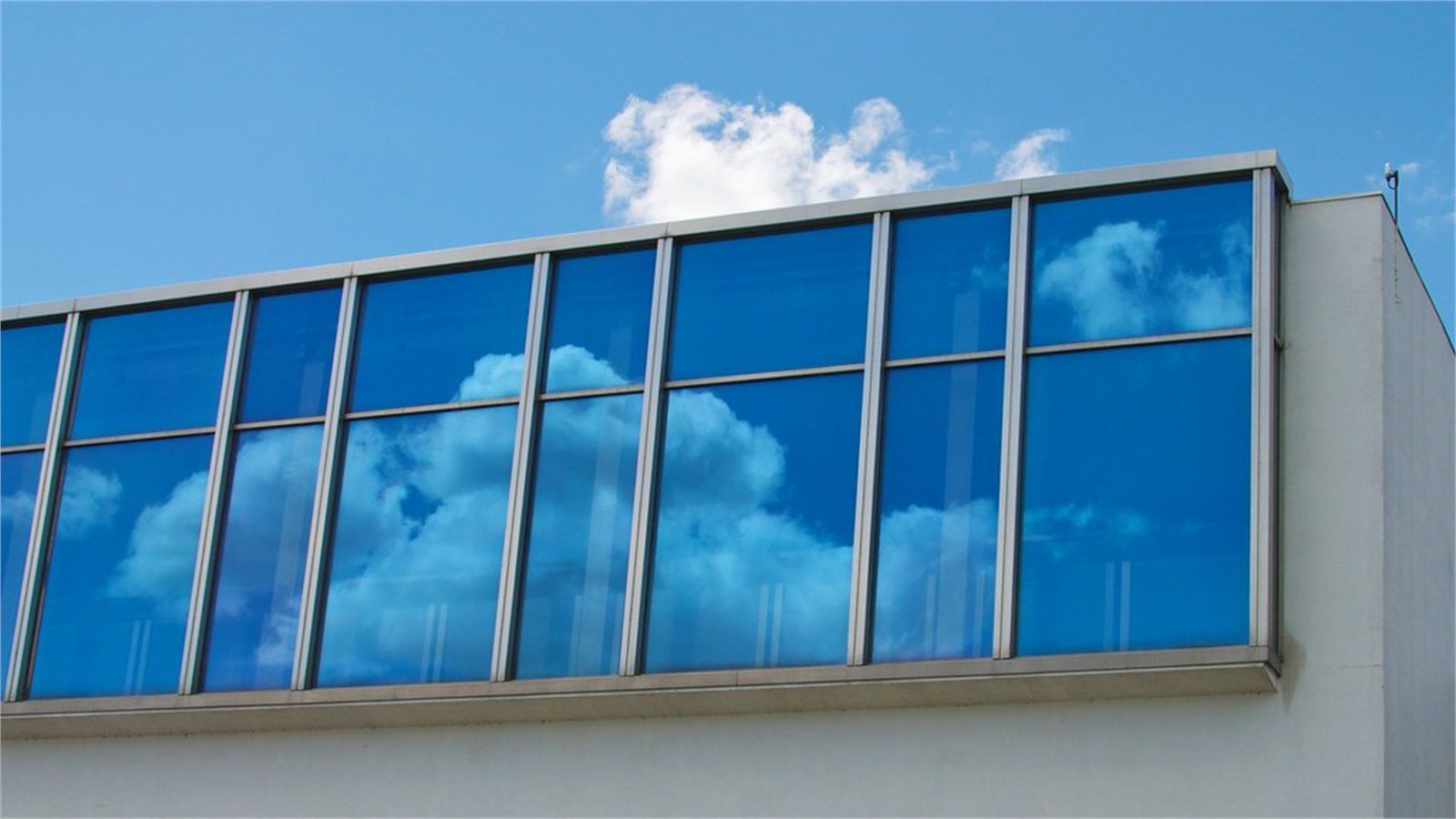 AWS Monthly Bill Spike: 7 Smart Cost Recovery Steps 16 cloud reflection on office windows representing AWS monthly bill storage and transfer costs