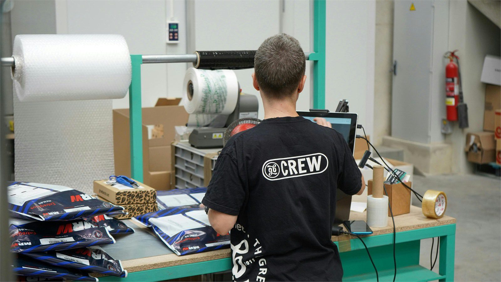 factory worker handling packaged goods representing compliance recall evidence and audit-ready records