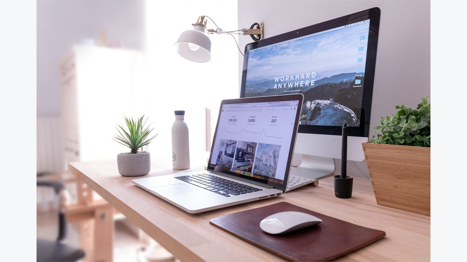 5 Cybersecurity Mistakes That Could Cost Your Small Business Everything 15 Clean office workspace with MacBook and iMac for answering frequently asked questions about cybersecurity mistakes