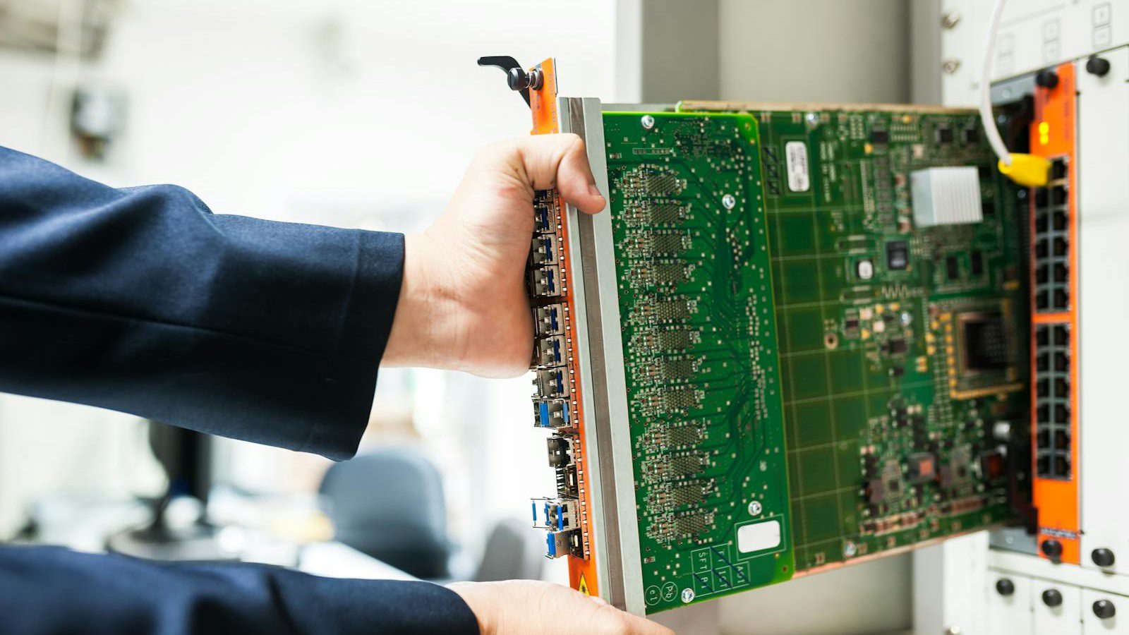Digital Carbon Footprint: 7 Powerful Ways to Cut It 17 technician inserting circuit board into a server rack for data-heavy digital workflows