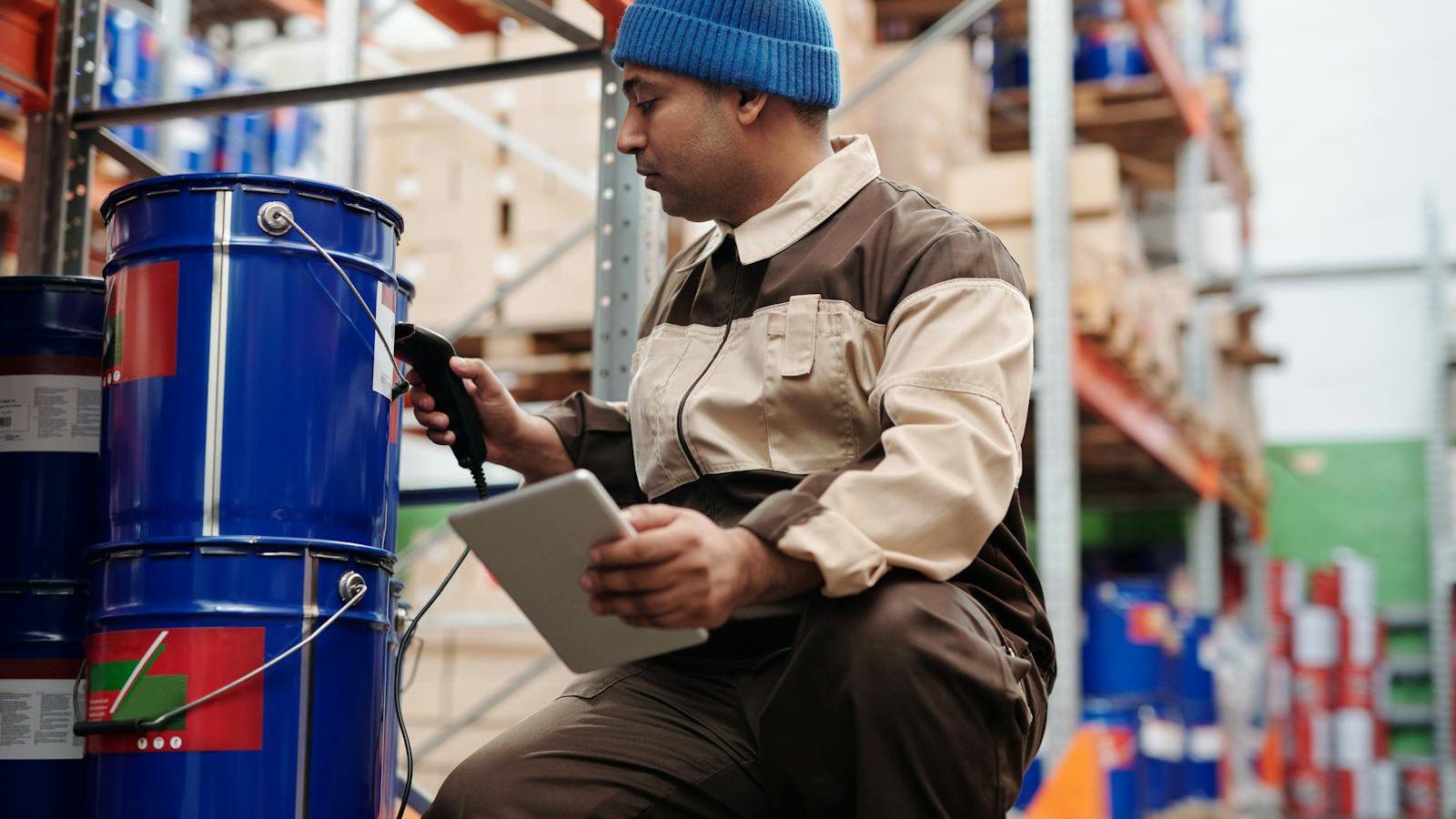 DLT Supply Chain Tracking: 7 Secure Wins Beyond Crypto 14 warehouse employee using scanner and tablet to capture barcode and handoff events