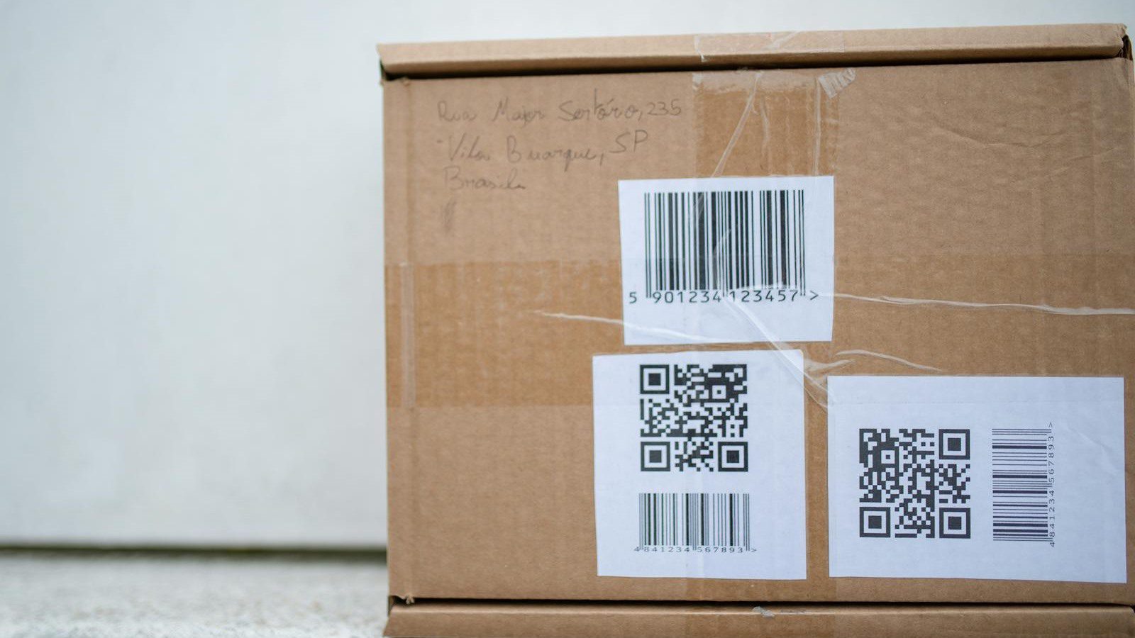 DLT Supply Chain Tracking: 7 Secure Wins Beyond Crypto 13 cardboard package with QR codes and barcode labels representing traceability standards and product identifiers
