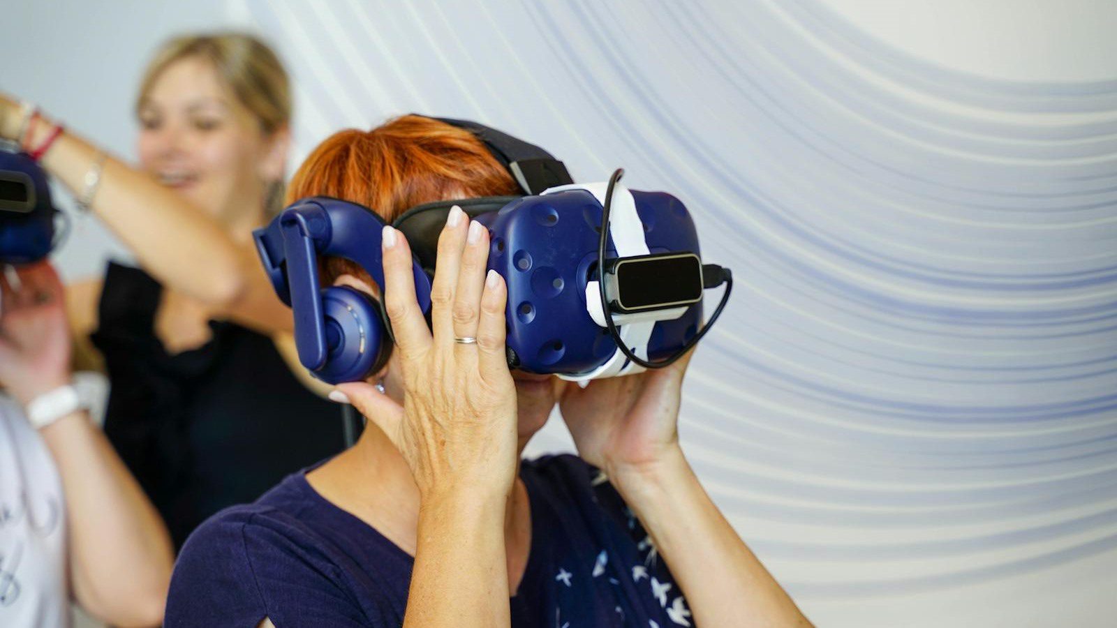 Extended Reality in Training: 7 Engaging Employee Wins 11 Extended Reality in Training at a glance with a group of employees using VR headsets indoors