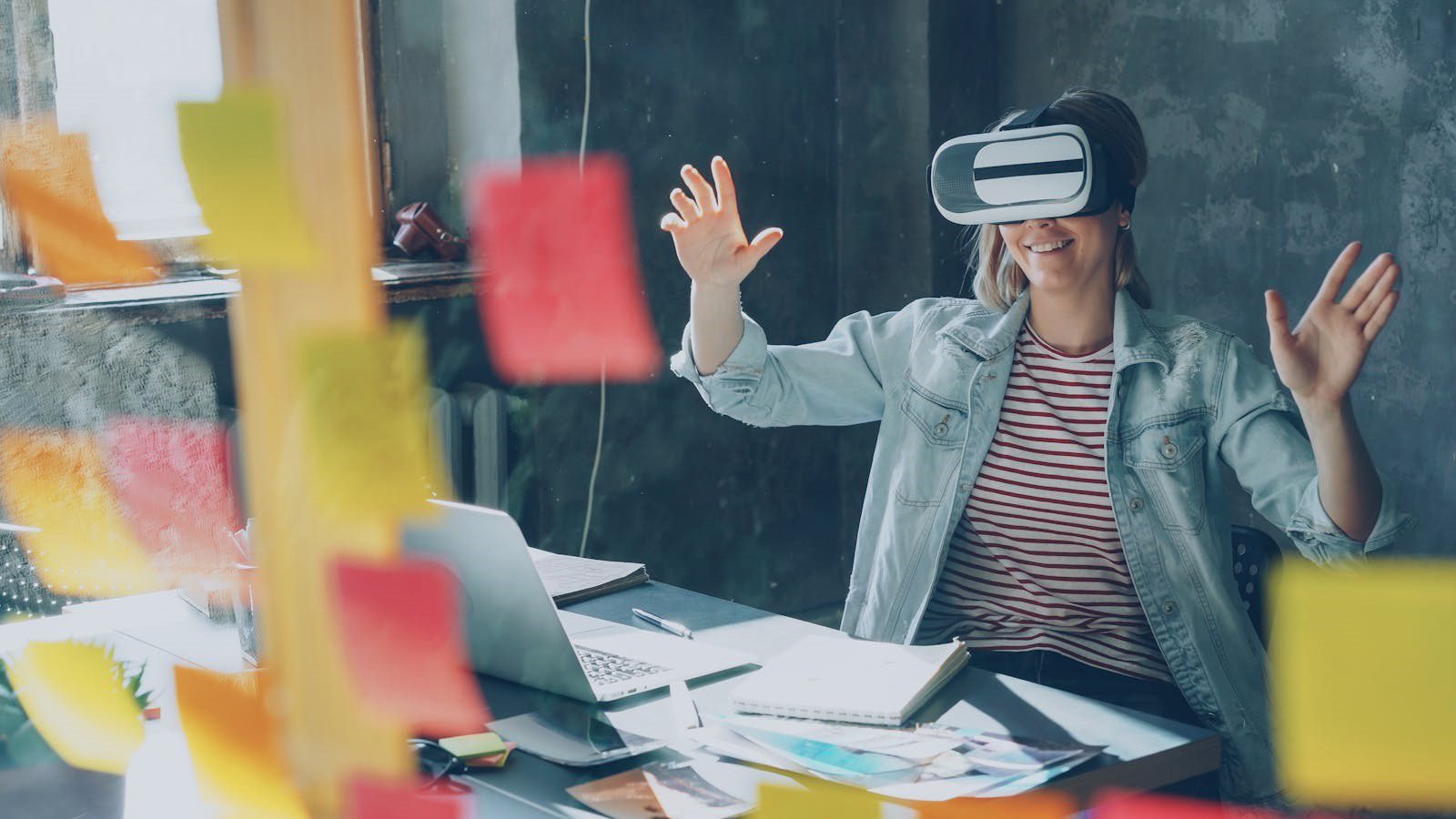 Extended Reality in Training: 7 Engaging Employee Wins 19 smiling employee using VR in an office for Extended Reality in Training FAQ topics