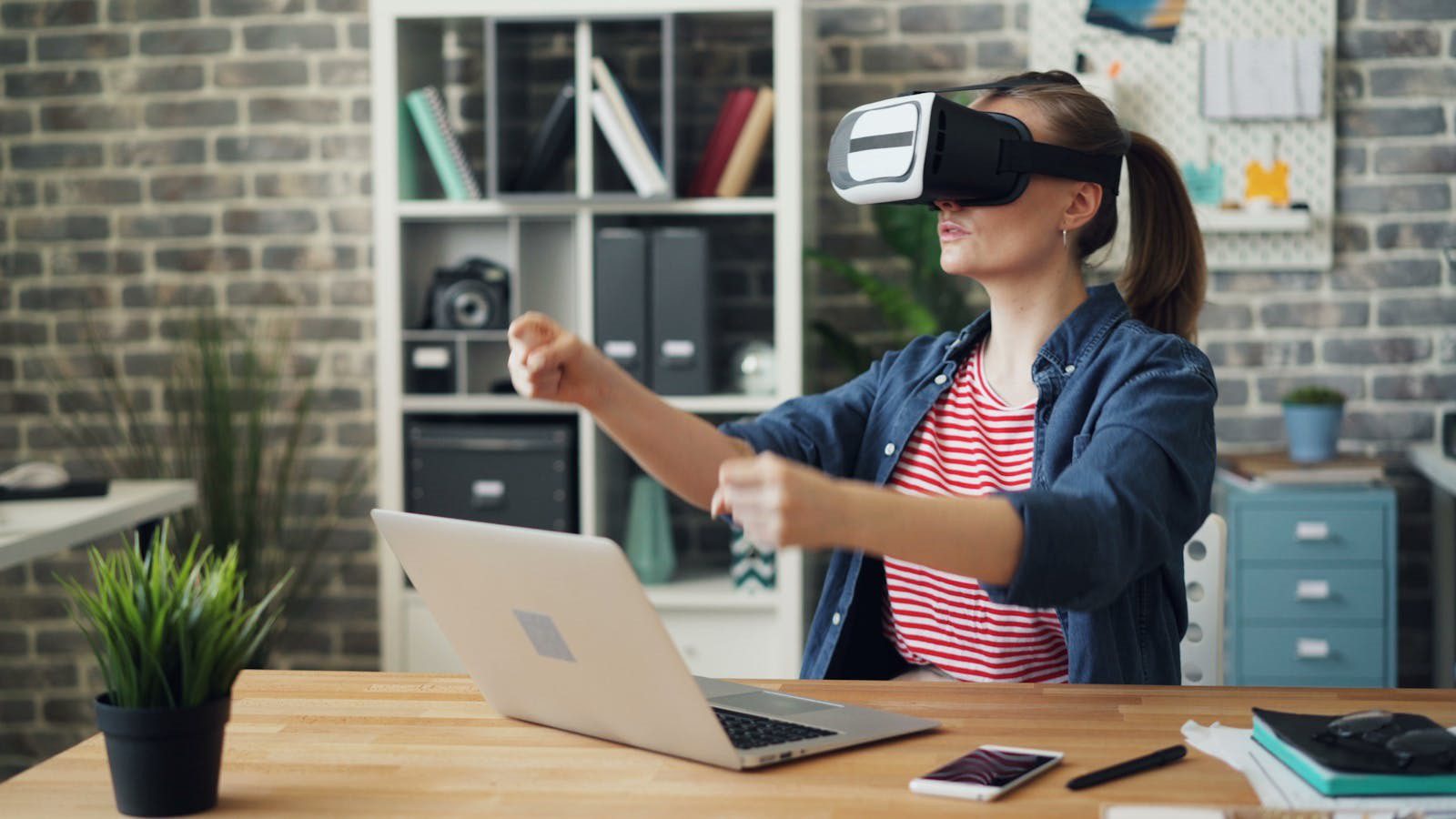 Extended Reality in Training: 7 Engaging Employee Wins 13 employee at a desk using a VR headset to experience realistic workplace simulation scenarios