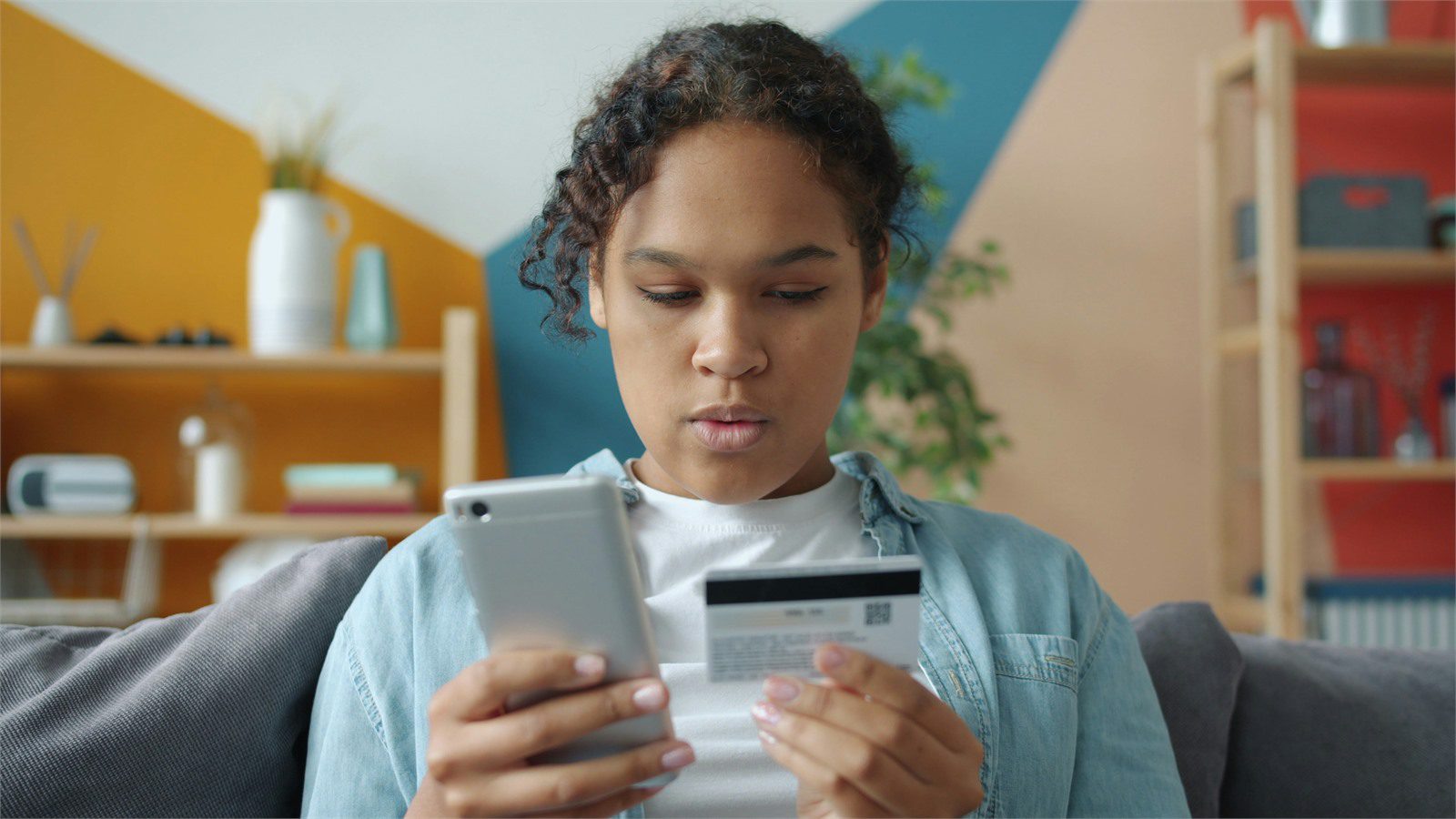 customer using a tablet and payment card representing device trust and mobile banking app integrity