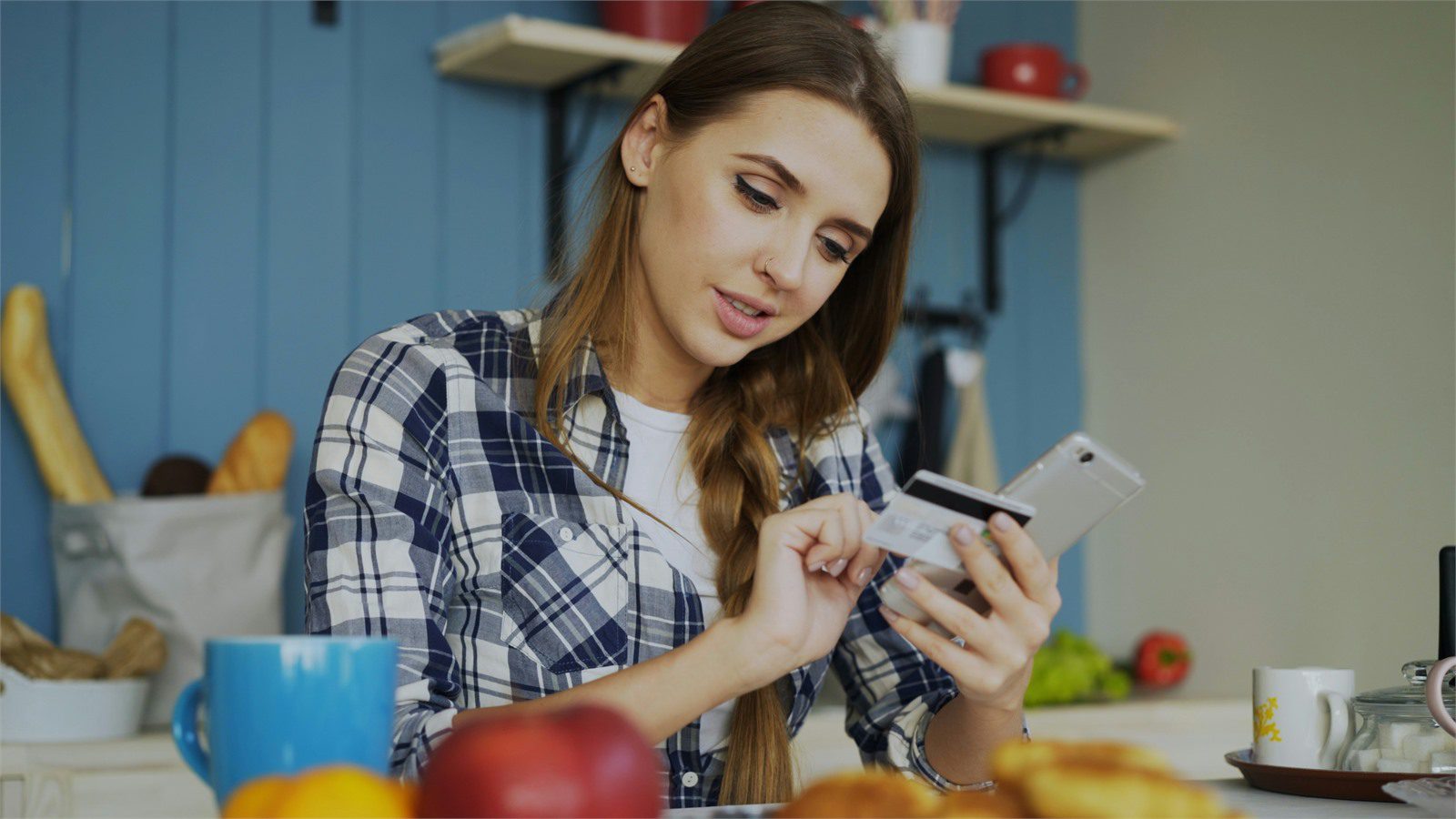 banking customer using a tablet and card representing compliance vendor governance and evidence review