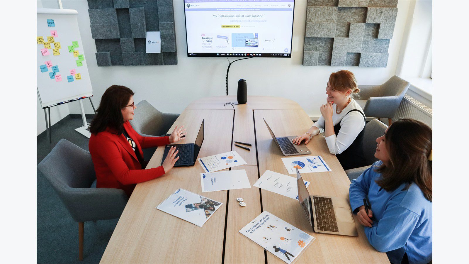 startup delivery team gathered around laptops for product operations planning