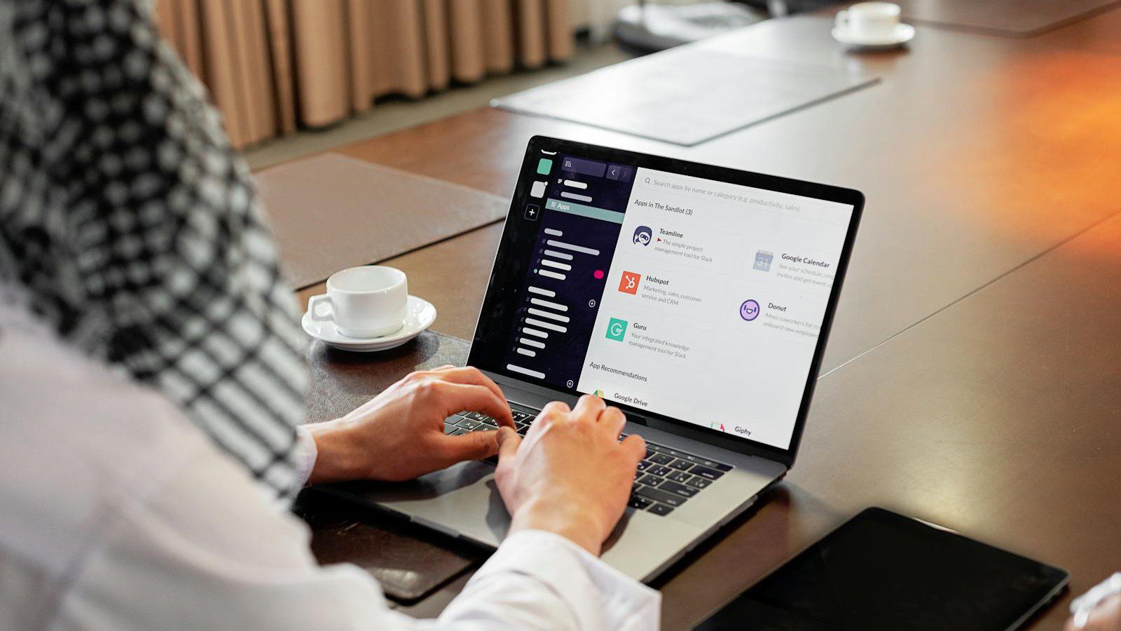 Google Workspace vs Microsoft 365: professional using a collaboration app on a laptop in an office