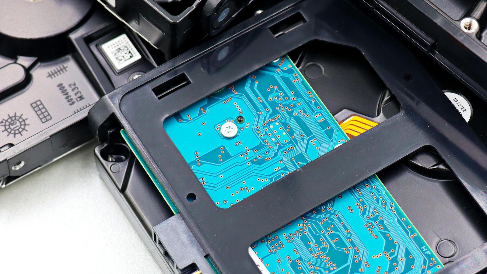 enterprise hardware decommissioning data sanitization compliance: stack of enterprise hard drives awaiting certified sanitization