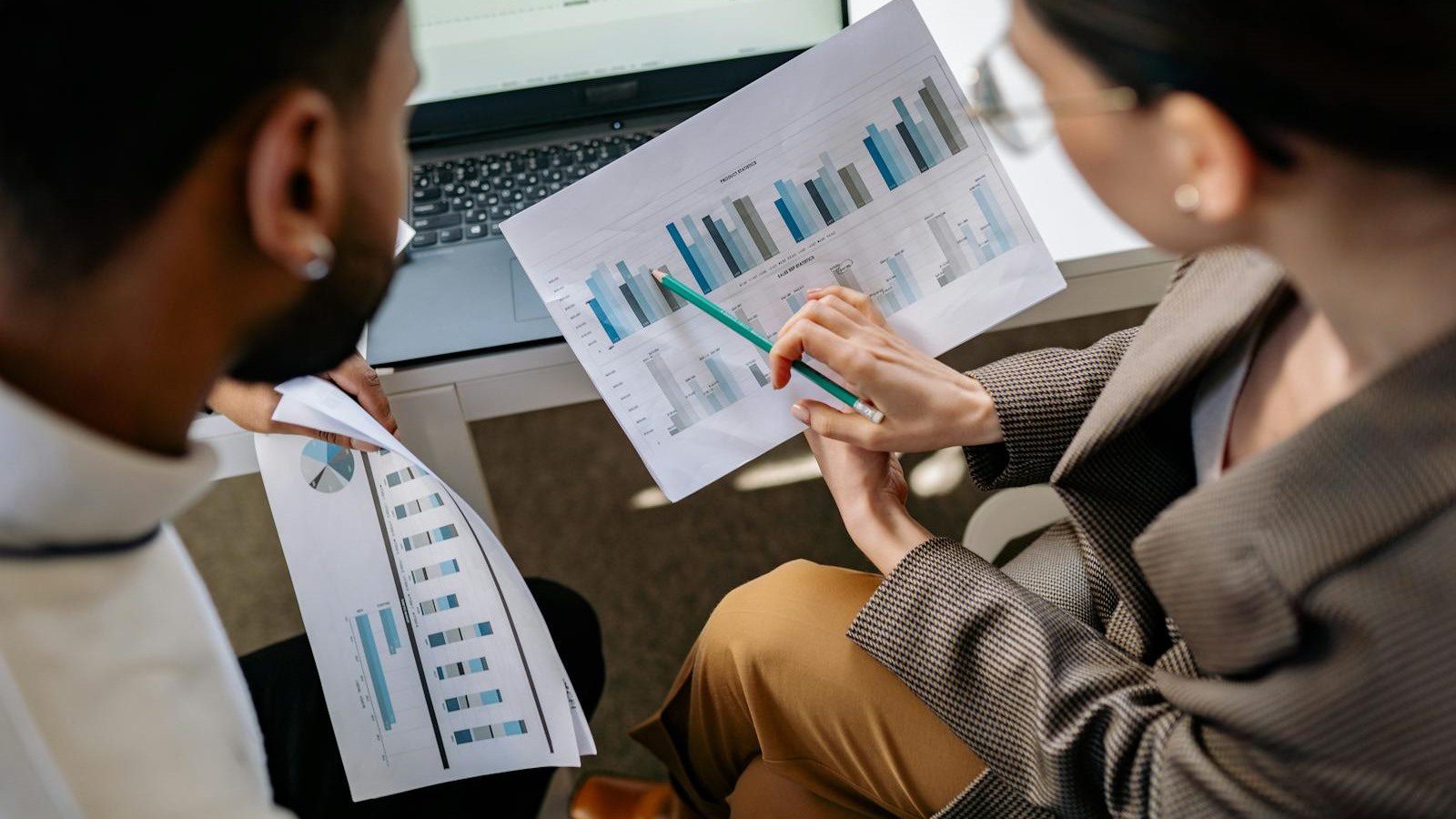 hiData.ai overview with colleagues reviewing charts and business data strategy