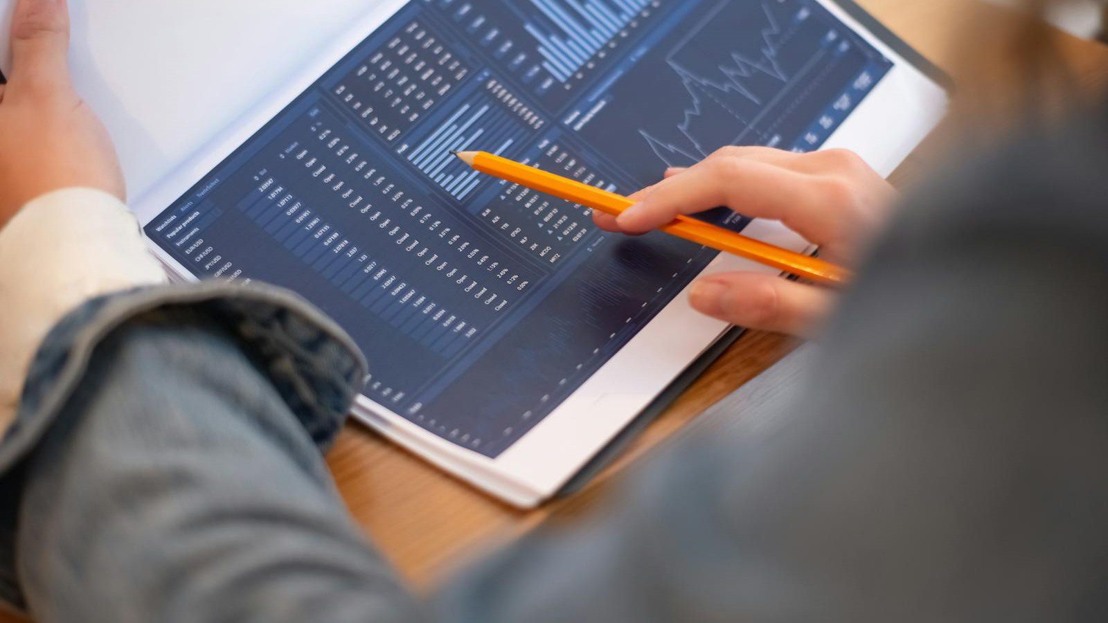 hands reviewing business analytics papers representing AI Table Creator document extraction