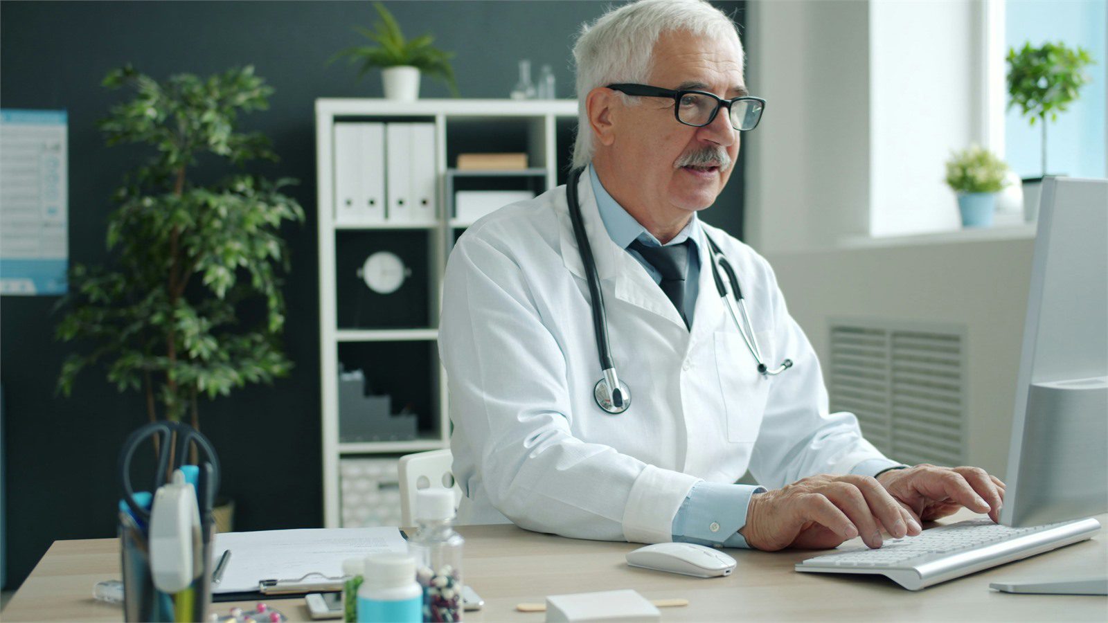 HIPAA-Compliant Software: 9 Critical Wins for Providers 16 clinician using a desktop computer representing identity access and minimum necessary controls