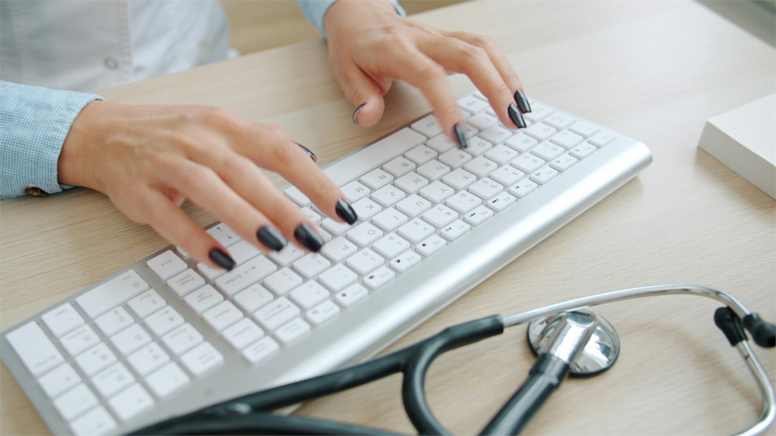 HIPAA-Compliant Software: 9 Critical Wins for Providers 22 HIPAA-compliant software operations shown by a clinician typing at a secure healthcare workstation
