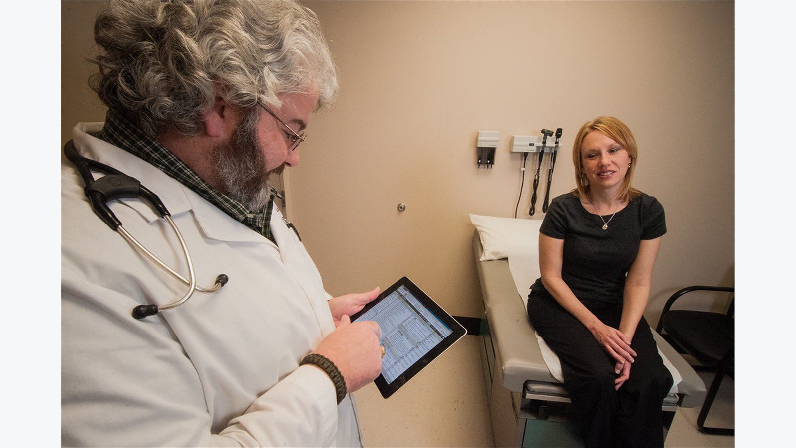 clinician using tablet for encrypted patient record sharing and controlled secure links