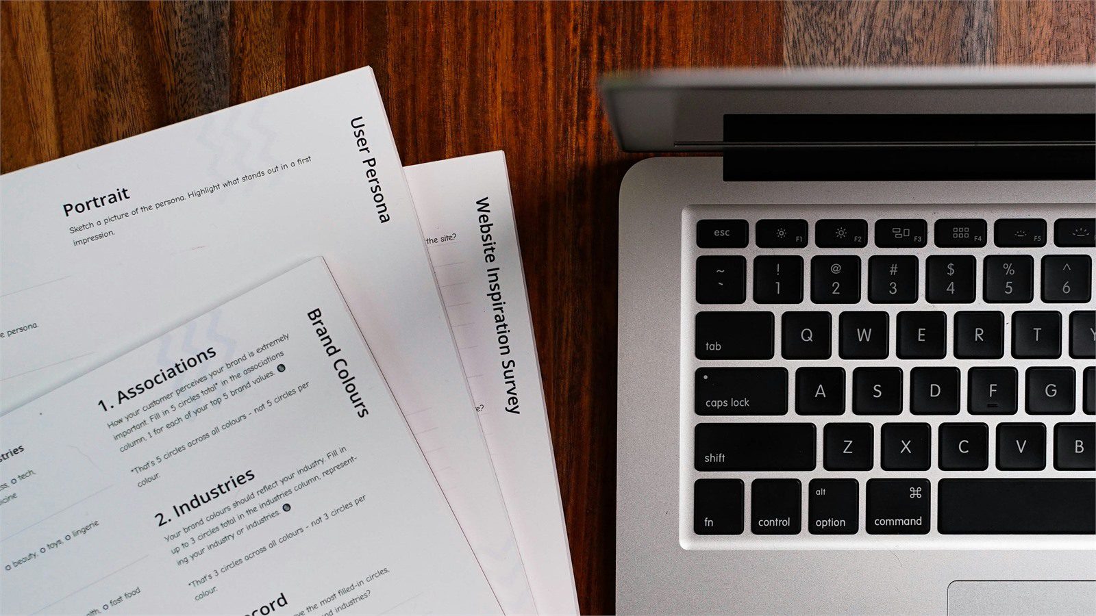 HR and Payroll Automation: 9 Powerful Secure Portal Wins 16 onboarding documents beside laptop for secure HR portal document collection