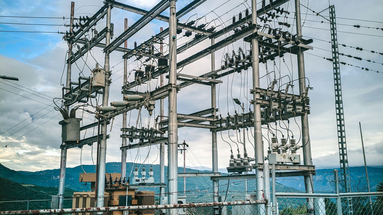 hybrid IT infrastructure energy efficiency consulting: electrical substation showing grid constraints behind data center power allocations