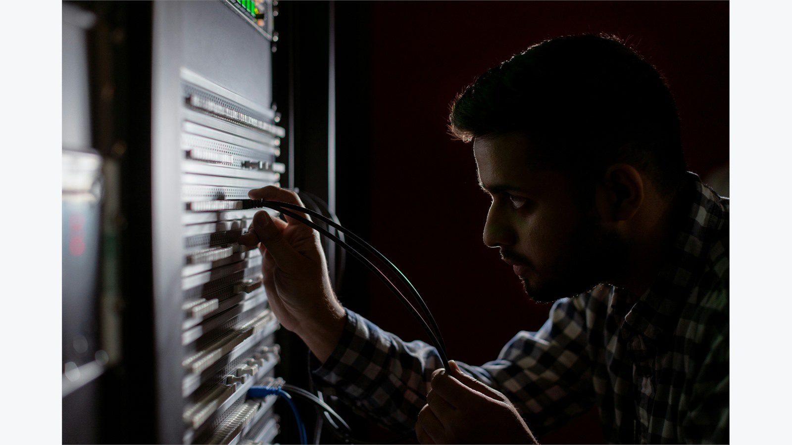 engineer working in server racks representing containment and recovery decisions during an incident