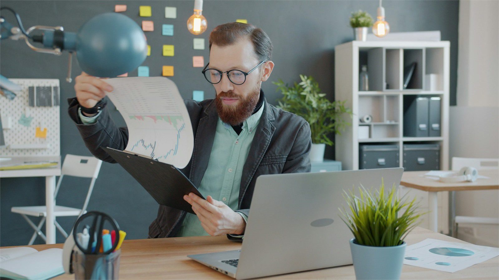 leader reviewing documents for IT spend and unit cost decisions