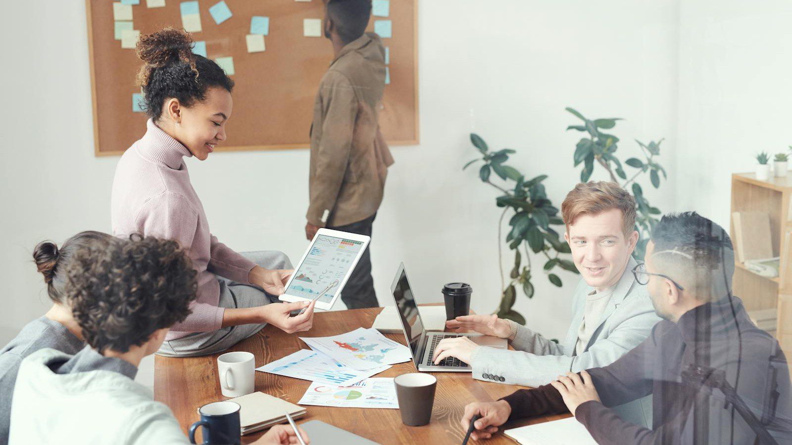 The IT Skills Gap: How an MSP Gives You Instant Access to Top-Tier Tech Talent 6 IT skills gap: a technology team collaborating around laptops in a modern office.